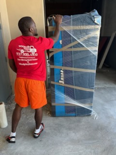 Woody and Sons mover carefully protecting a large item